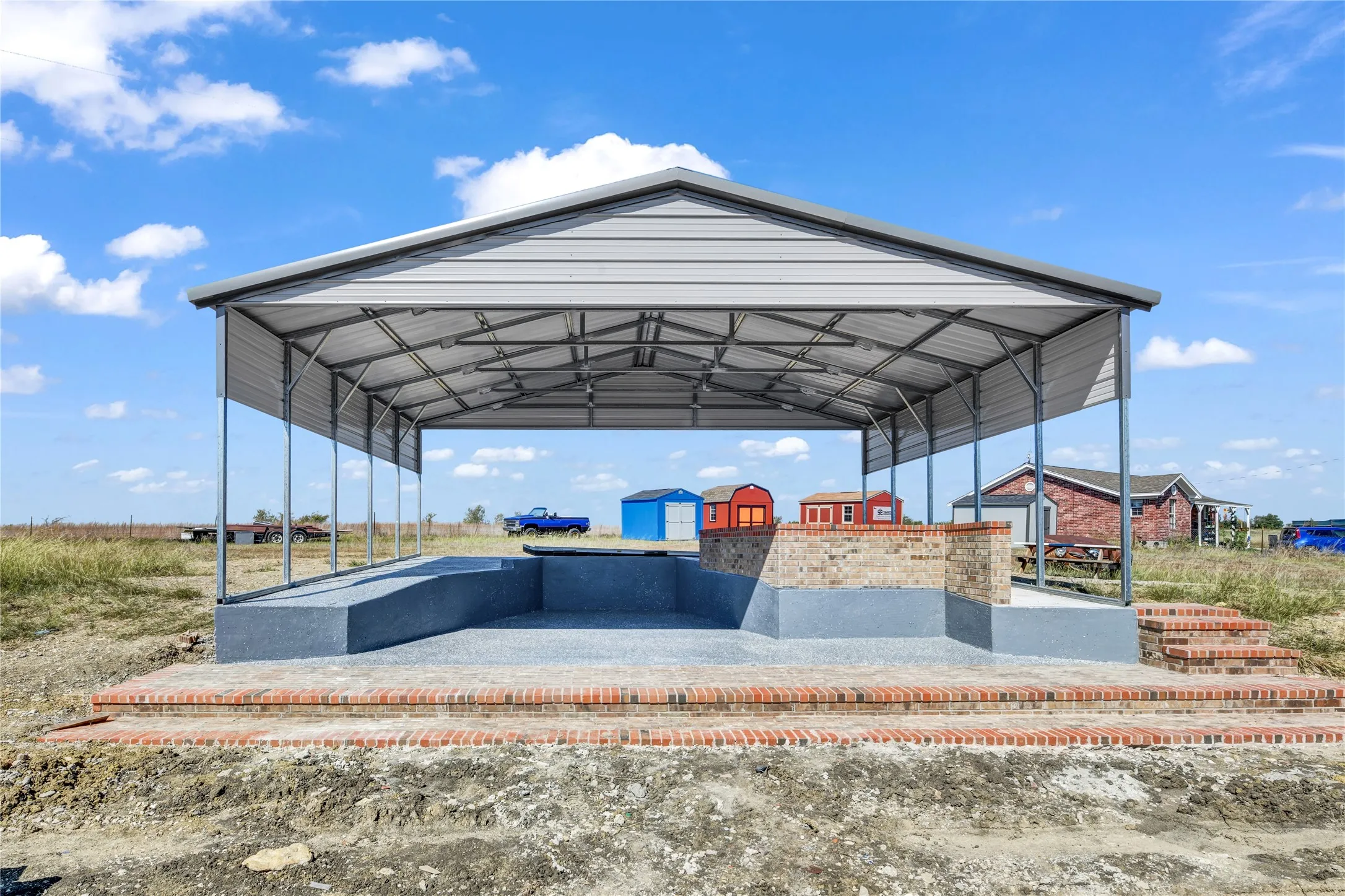 View of home's community with a patio, a gazebo, a carport, and an outdoor structure