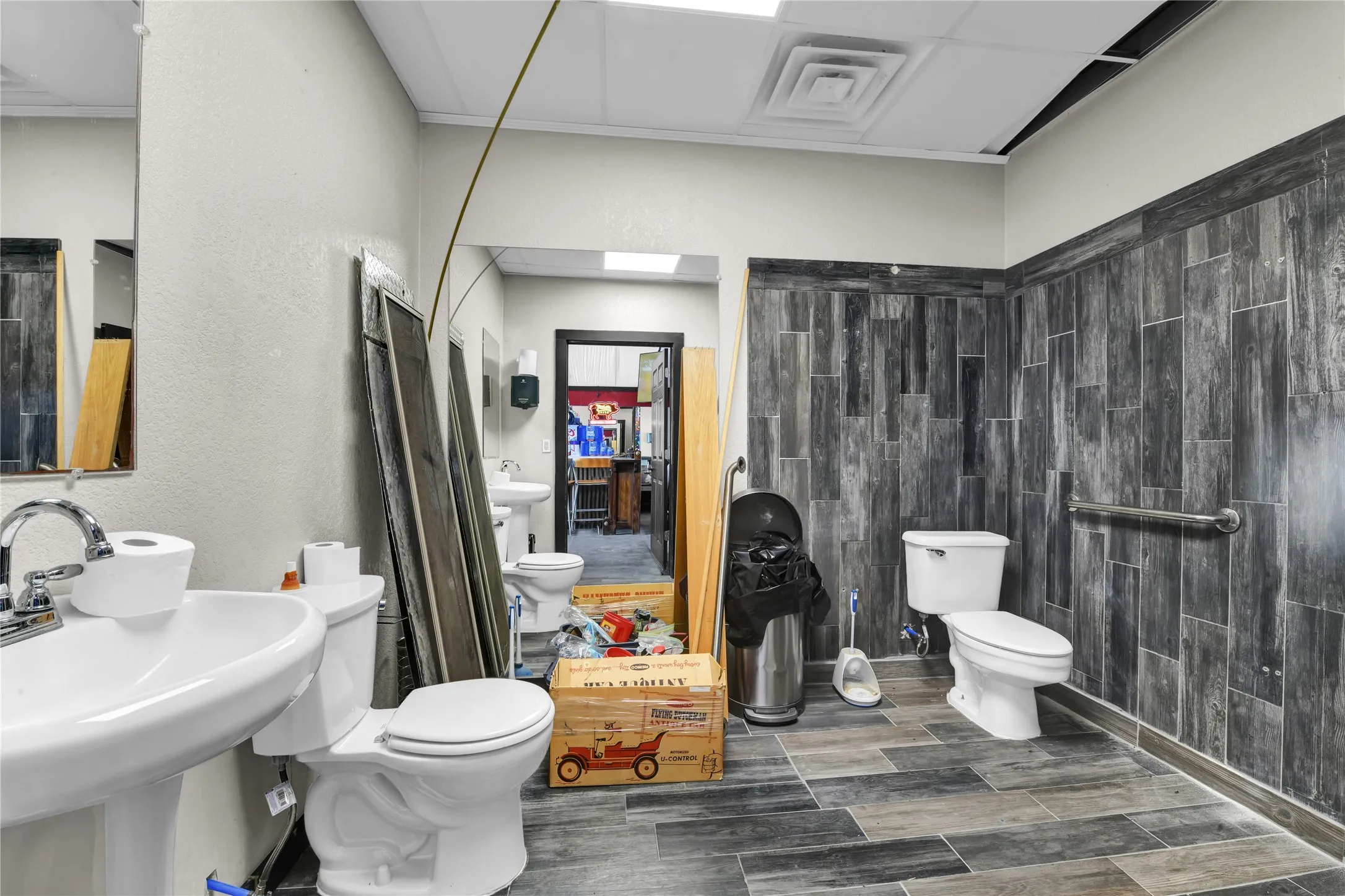 Bathroom featuring toilet and wood tiled floors
