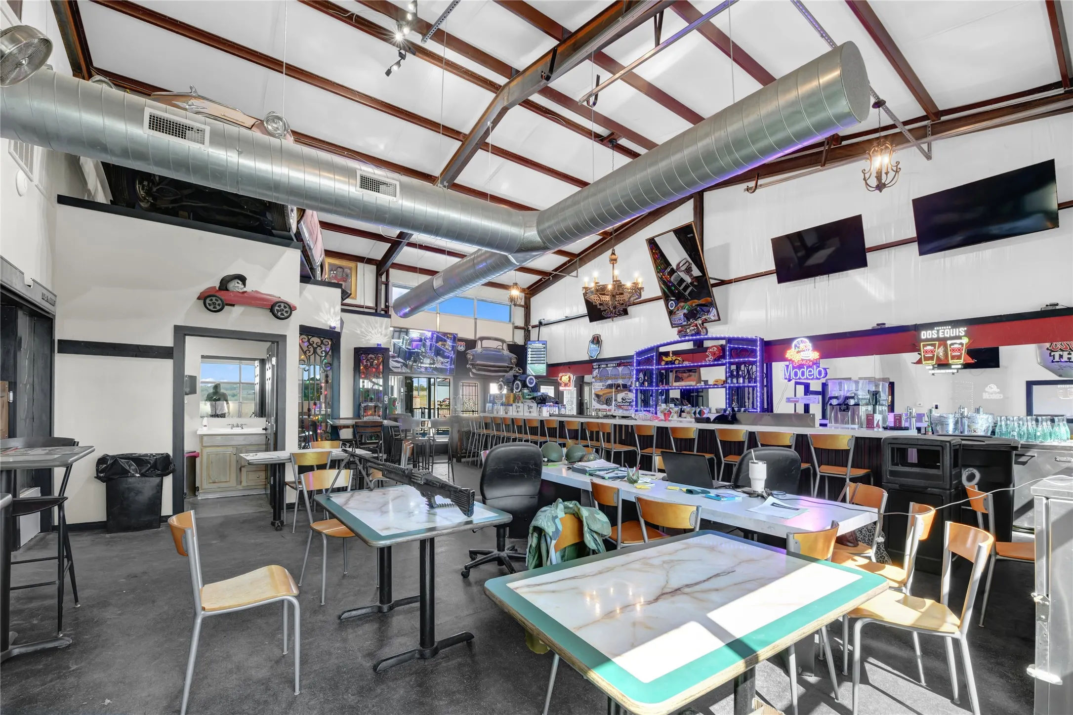 Dining space with a high ceiling and concrete flooring