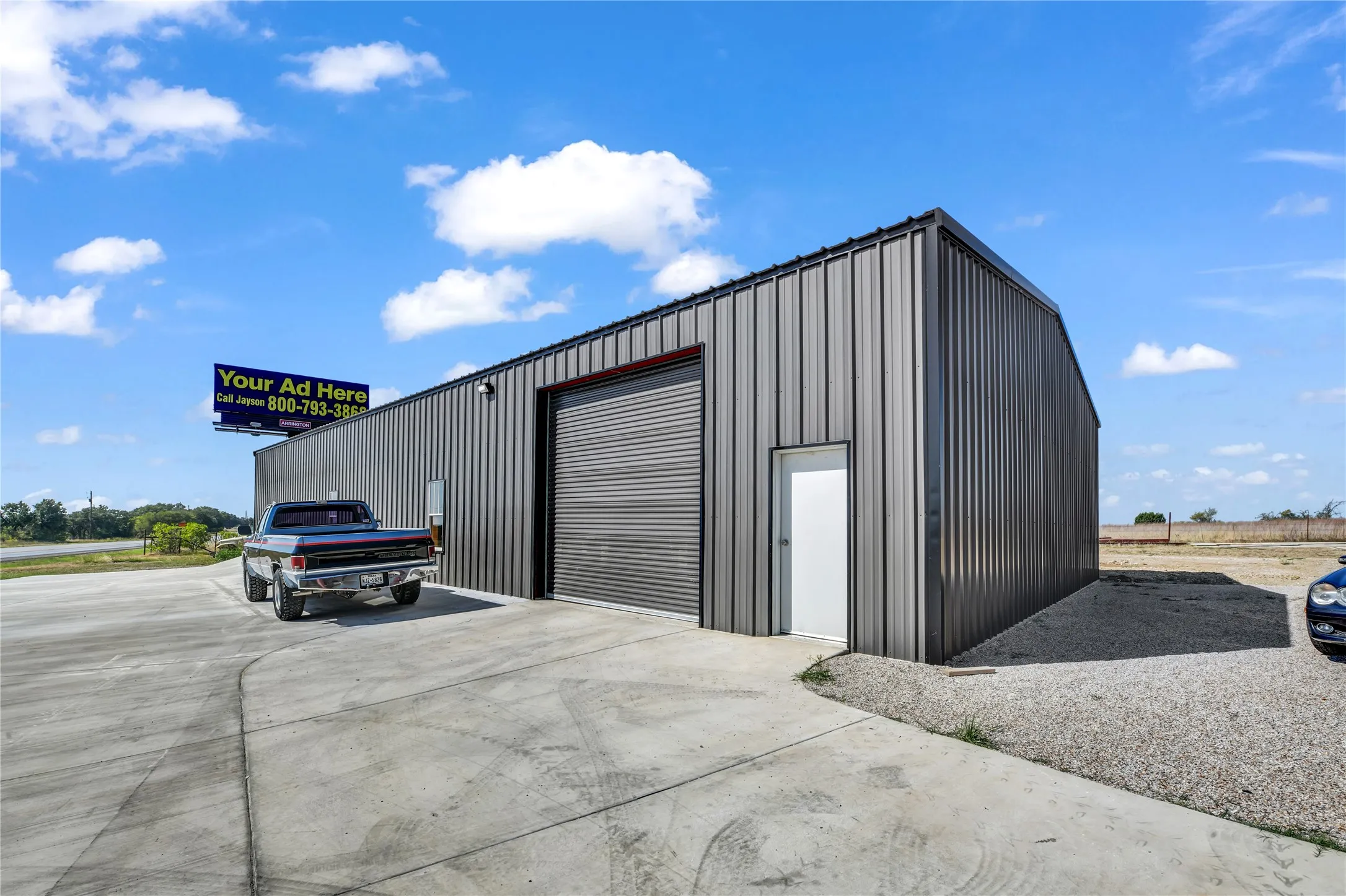 View of outdoor structure with concrete driveway