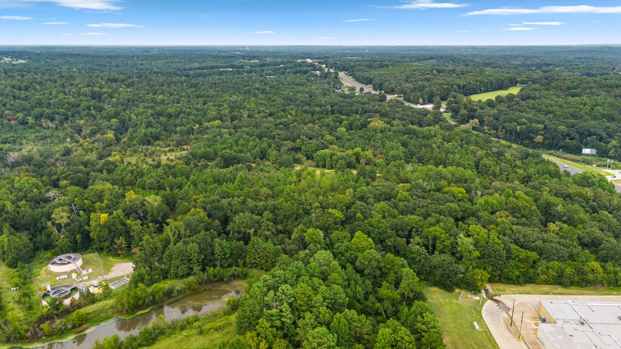 Bird's eye view of a large body of water and a heavily wooded area
