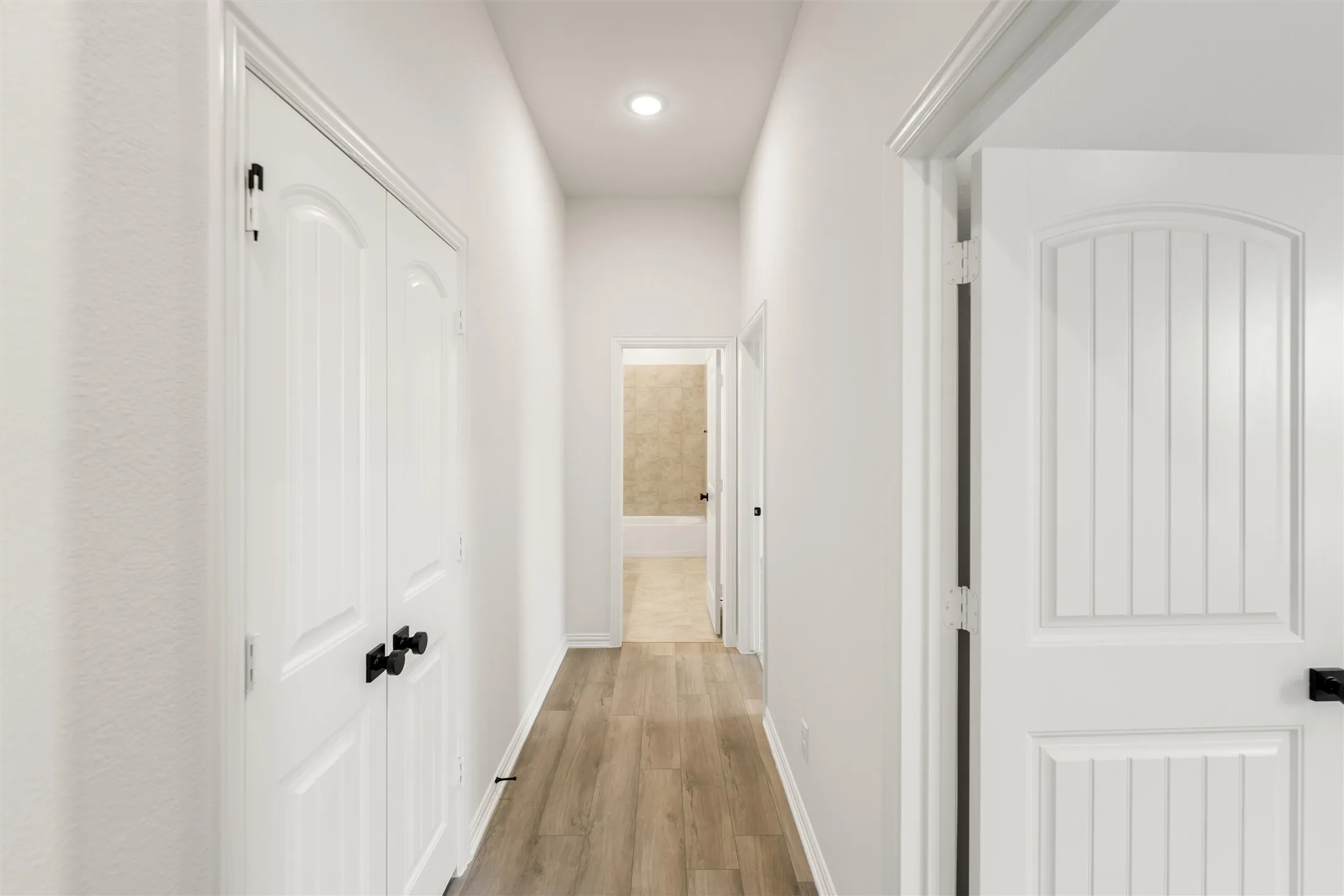 Corridor featuring light wood-style floors and recessed lighting