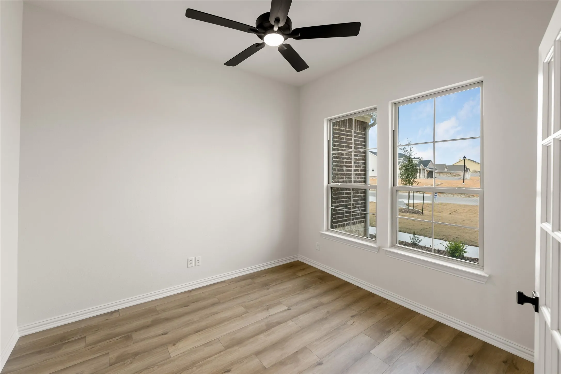 Empty room with light wood finished floors and a ceiling​​‌​​​​‌​​‌‌​‌‌​​​‌‌​‌​‌​‌​​​‌​​ fan