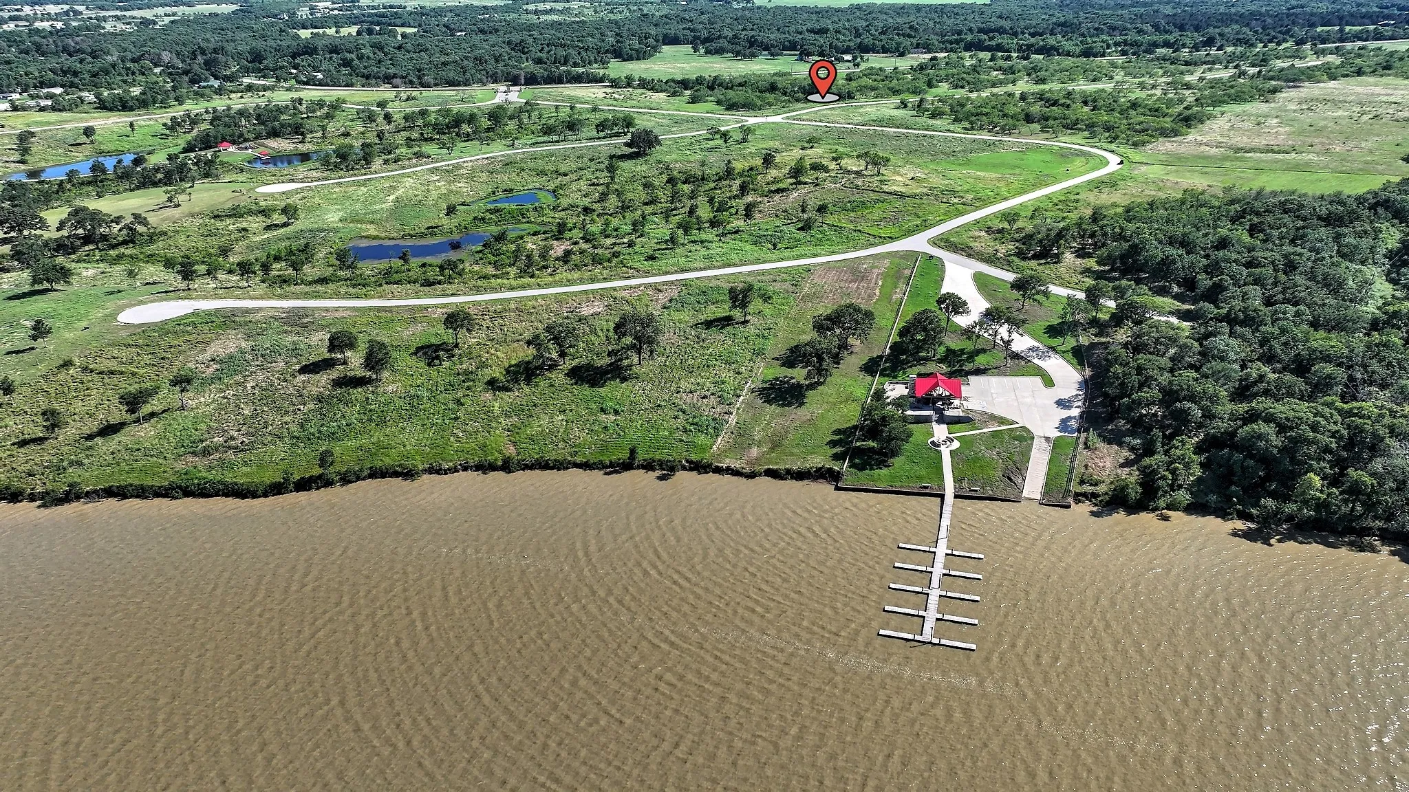 Aerial overview of property's location featuring a large body of water