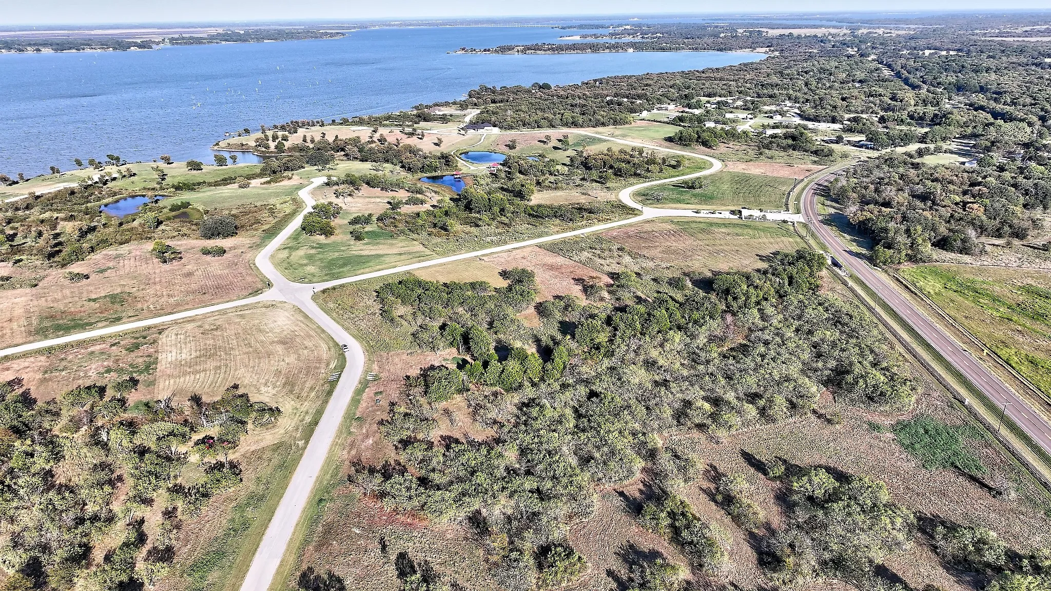 Aerial view of property and surrounding area with a large body of water
