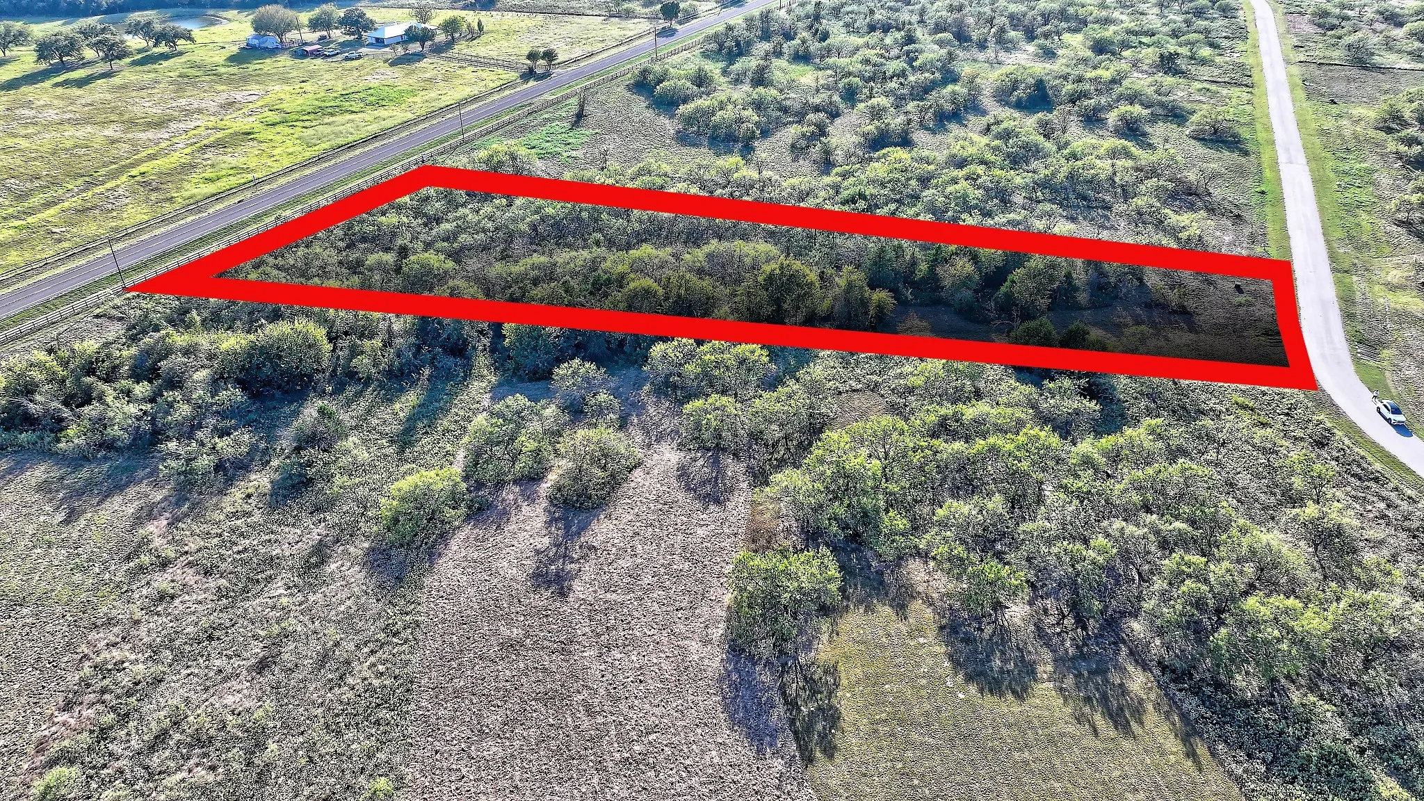 Aerial view of sparsely populated area with property boundaries highlighted