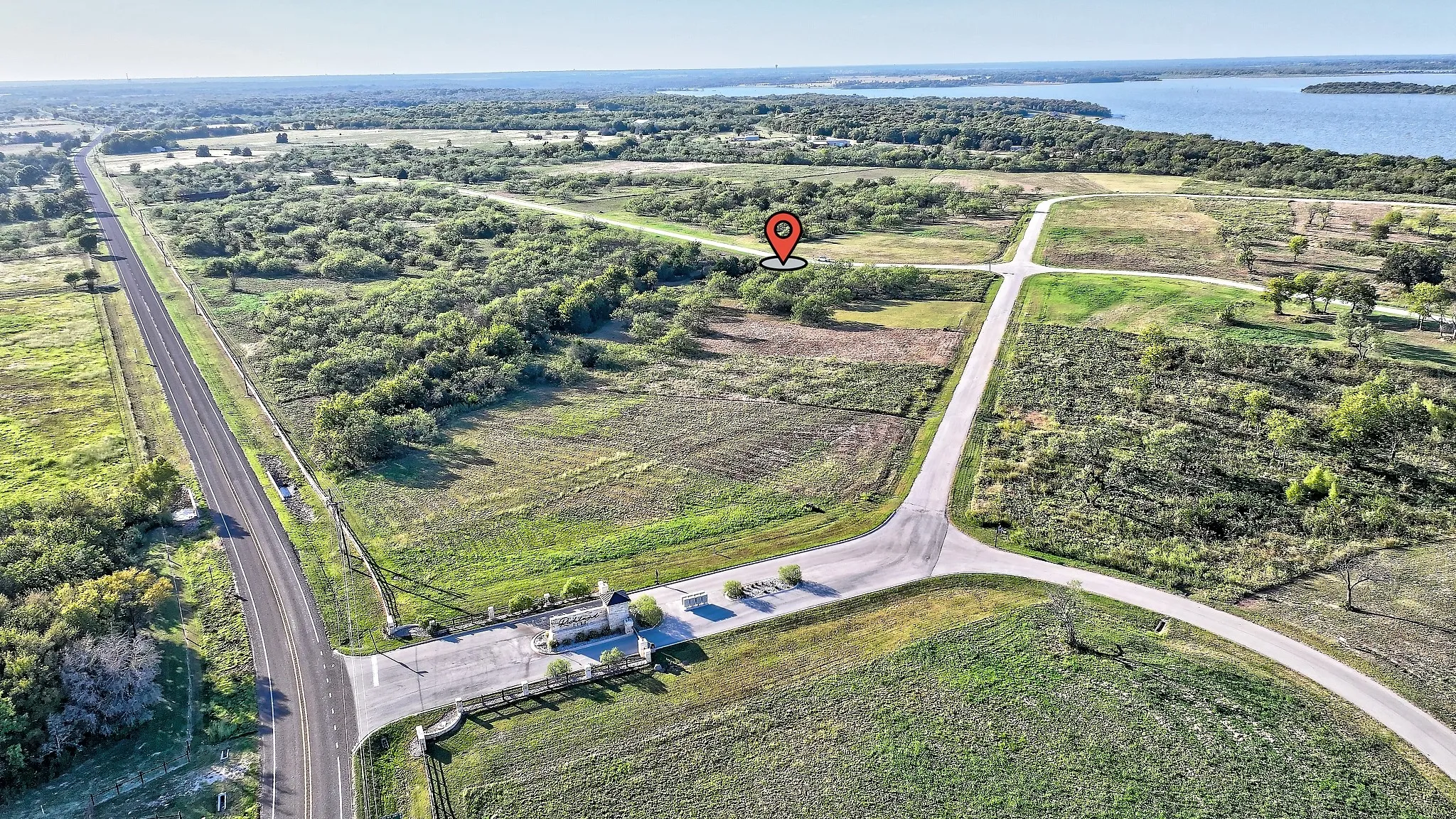 Aerial view of property's location with a large body of water