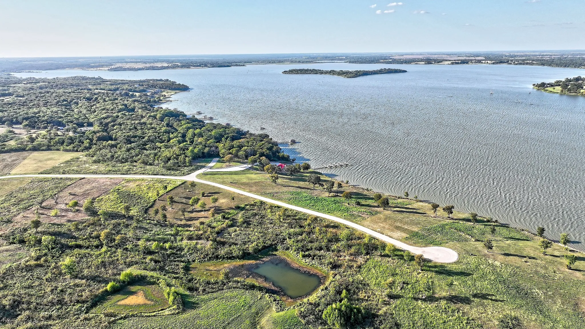 Aerial overview of property's location with property boundaries highlighted and a large body of water