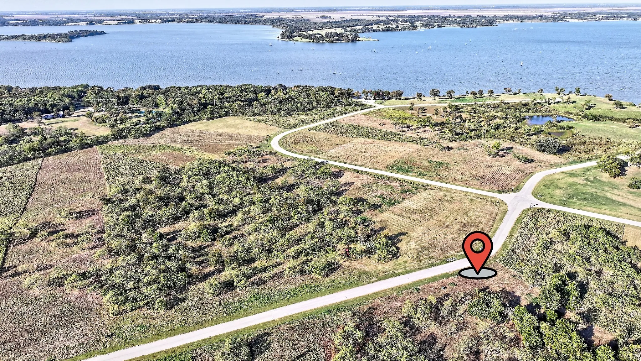 Aerial view of property's location featuring a large body of water
