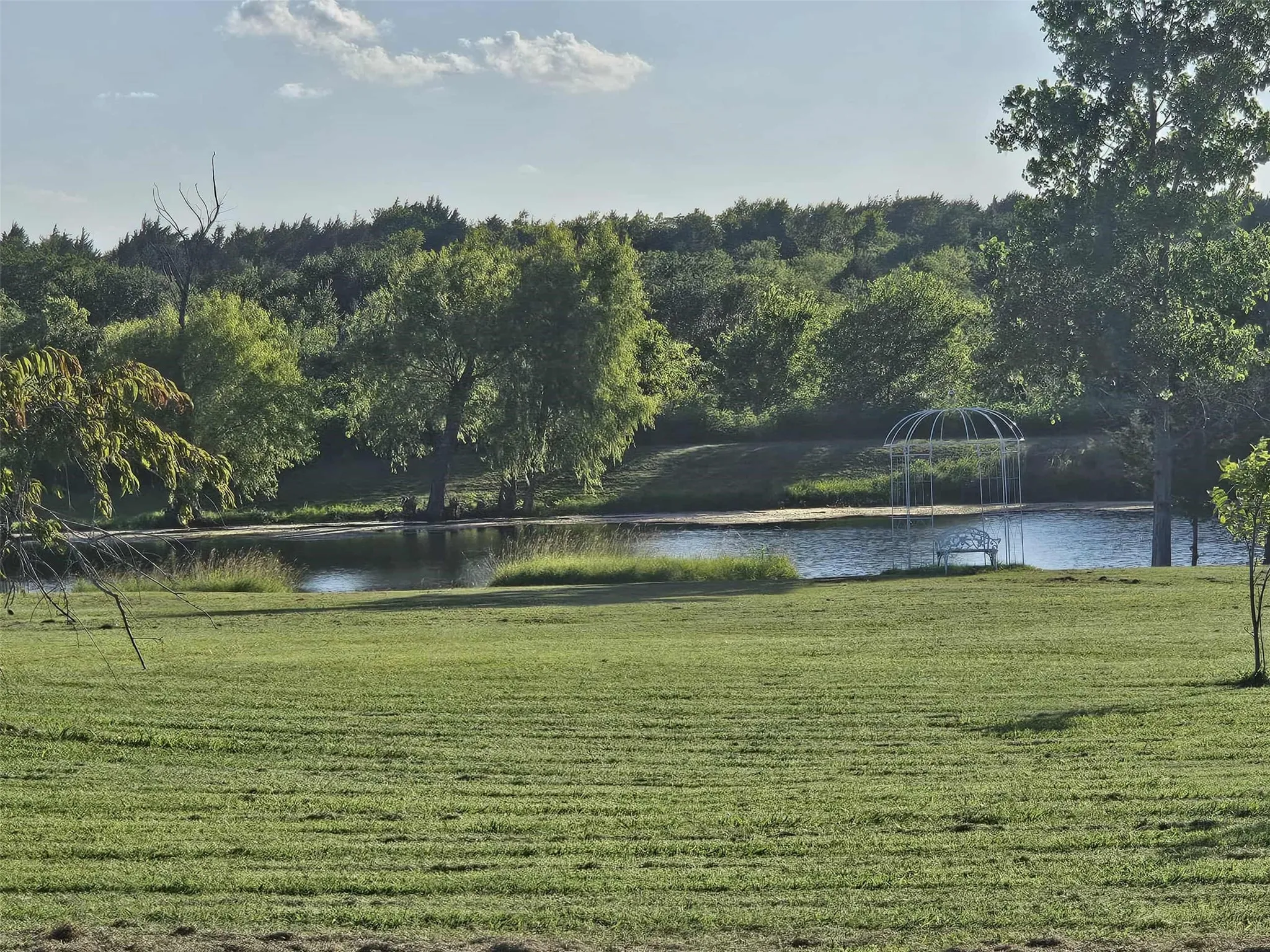 Water view with a heavily wooded area