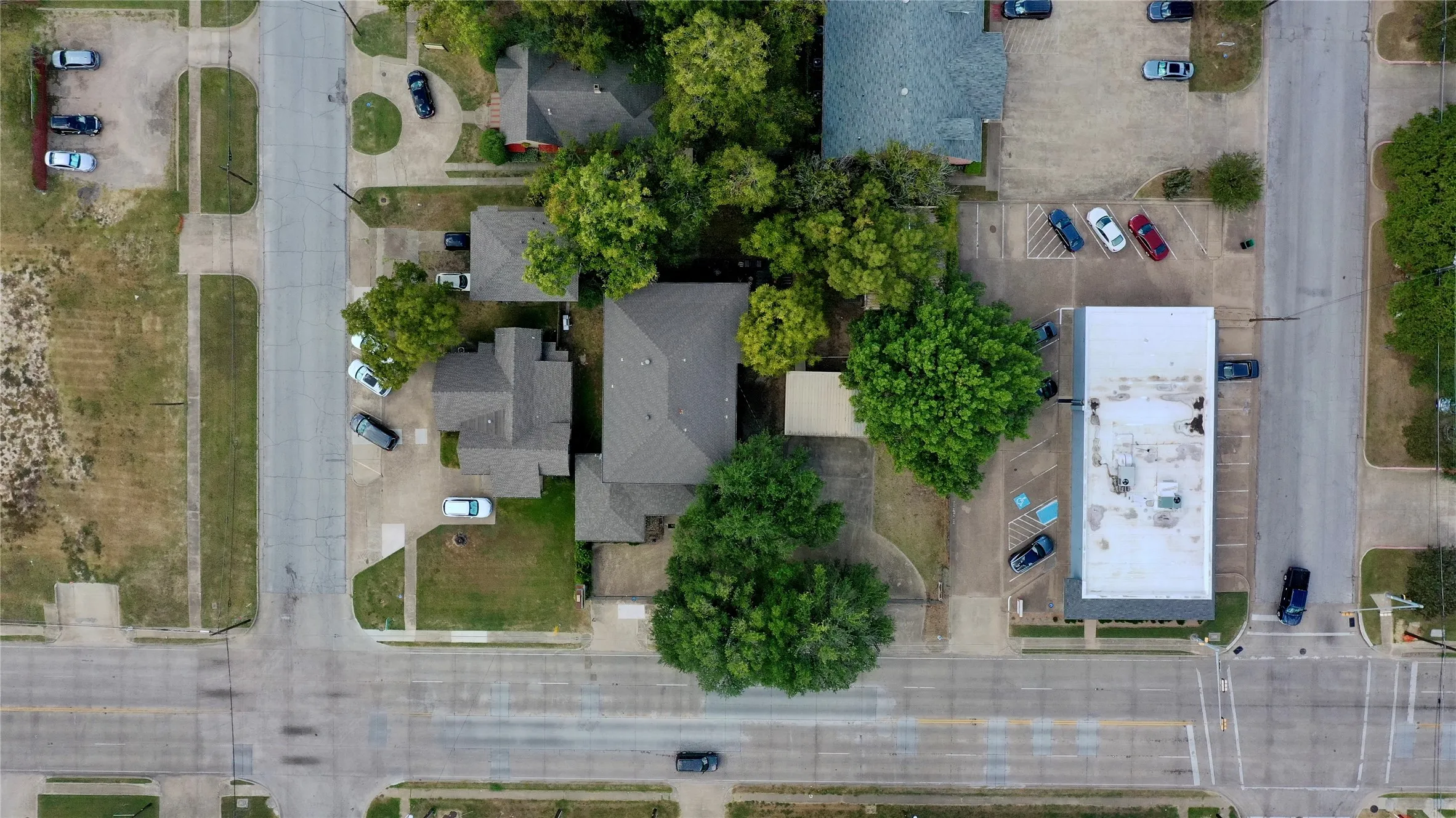 Aerial view of property and surrounding area with nearby suburban area