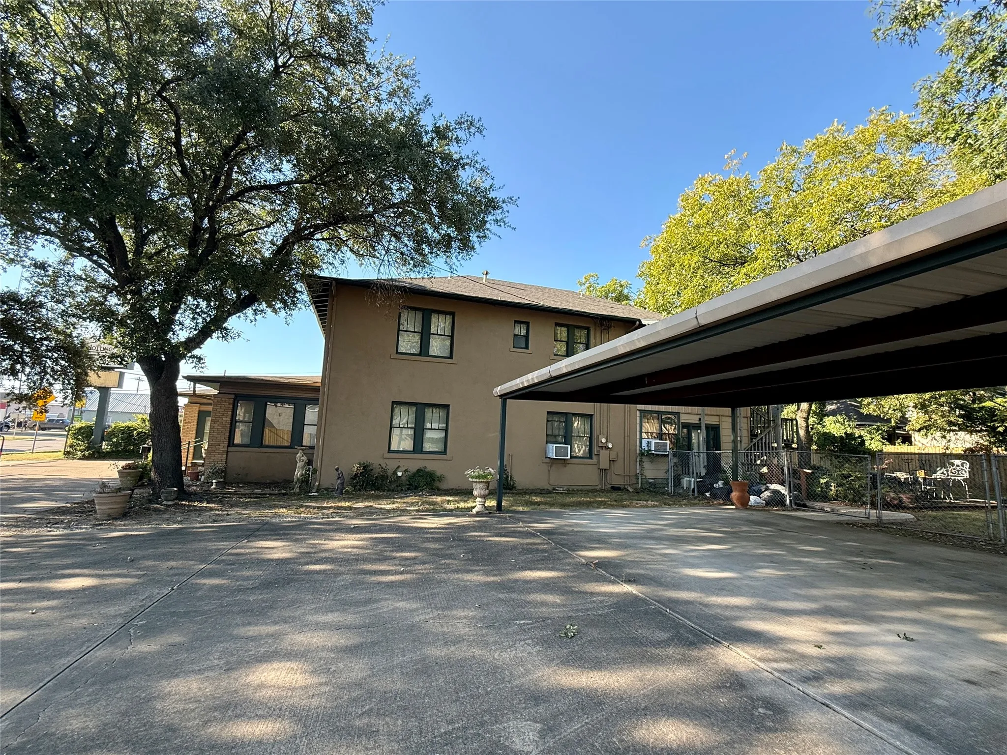 View of home's exterior featuring stucco siding and a carport