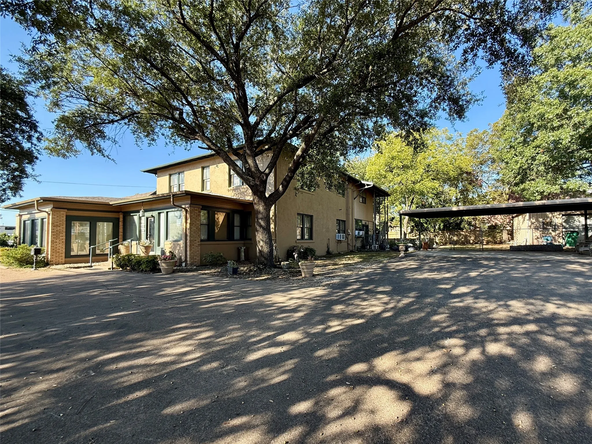 View of home's exterior with brick siding and a carport