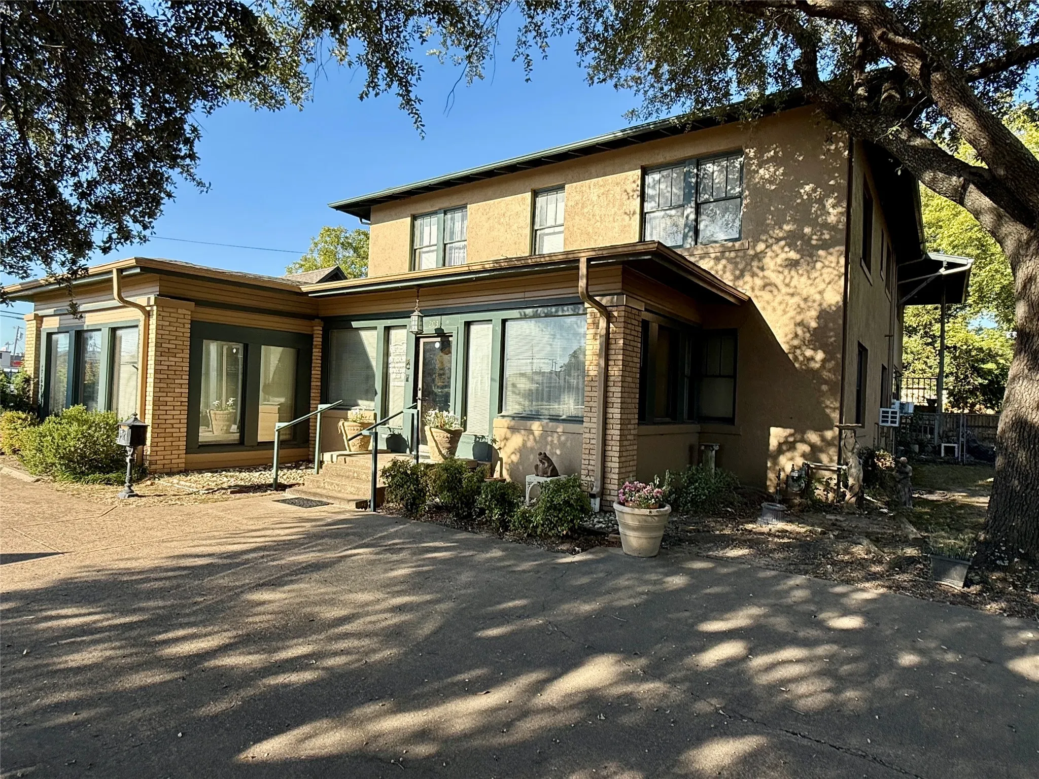 Rear view of property with brick siding and stucco siding
