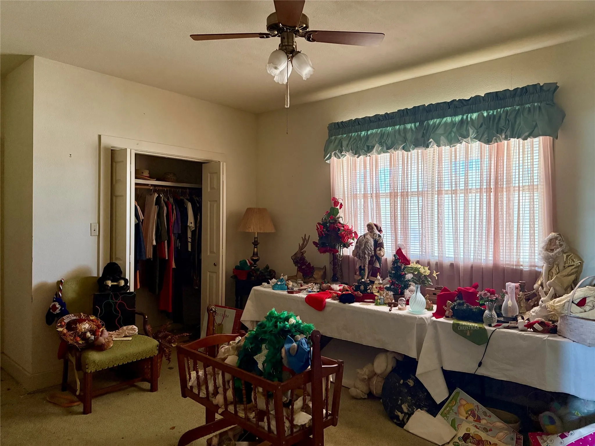 Carpeted dining room with ceiling fan