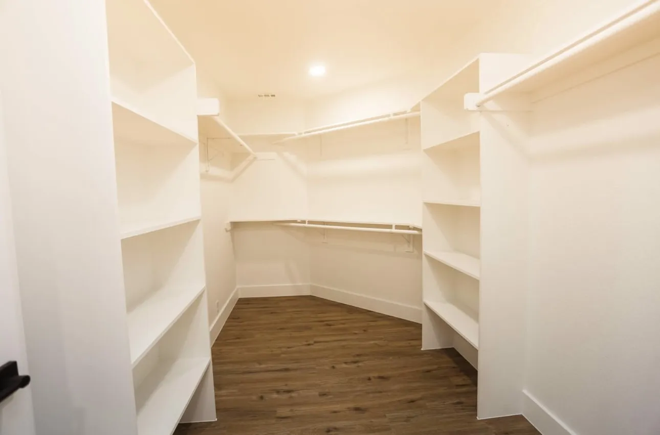 Spacious closet featuring dark wood-style floors