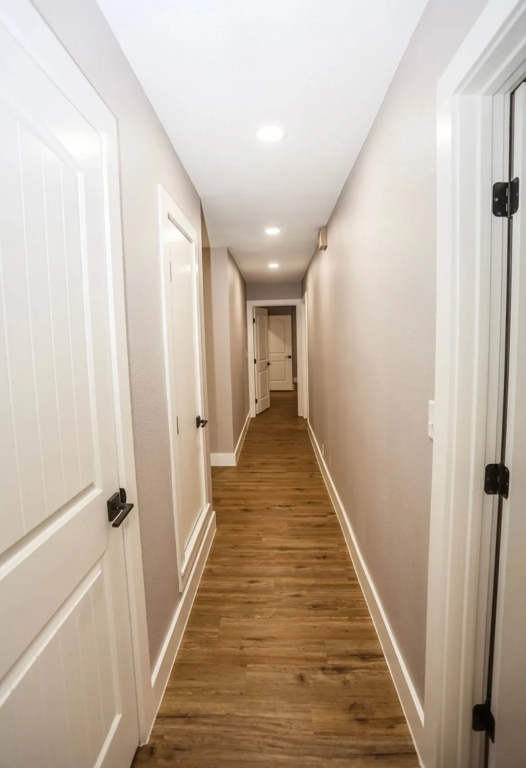 Hallway featuring dark wood finished floors and recessed lighting