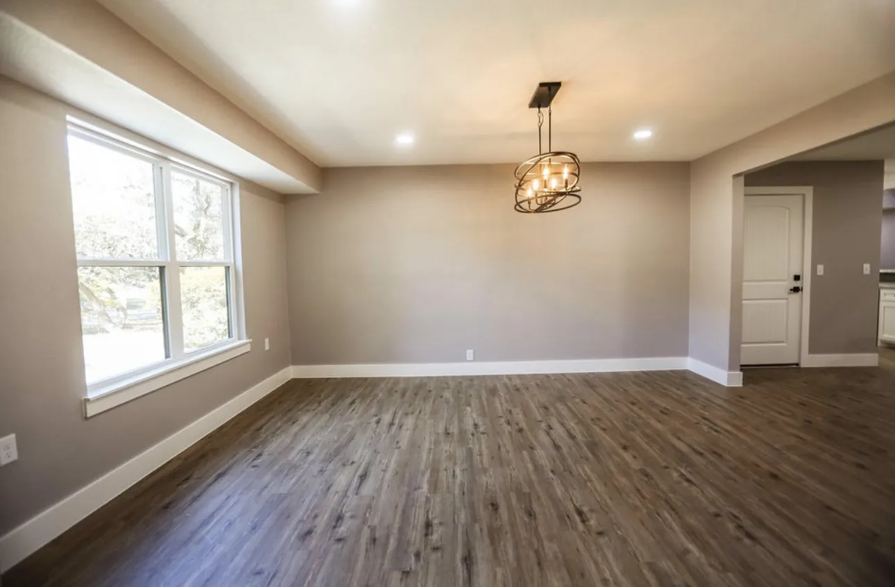 Unfurnished dining area with dark wood-style floors, recessed lighting, and a chandelier