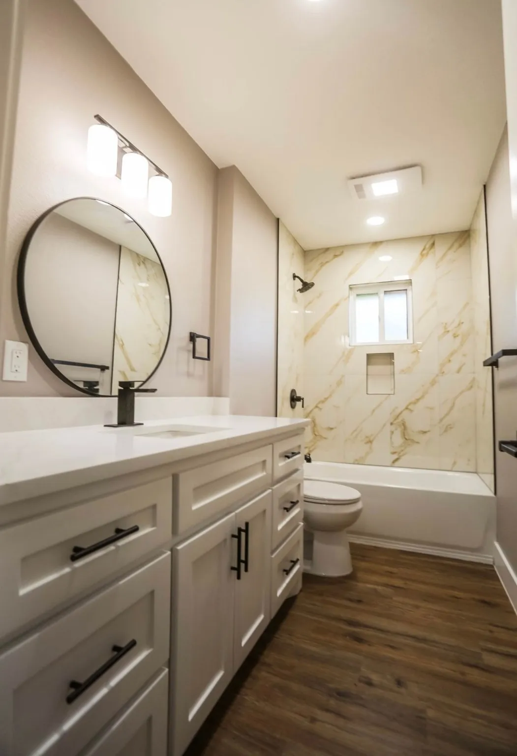 Full bath with vanity, shower / bath combination, and dark wood-type flooring