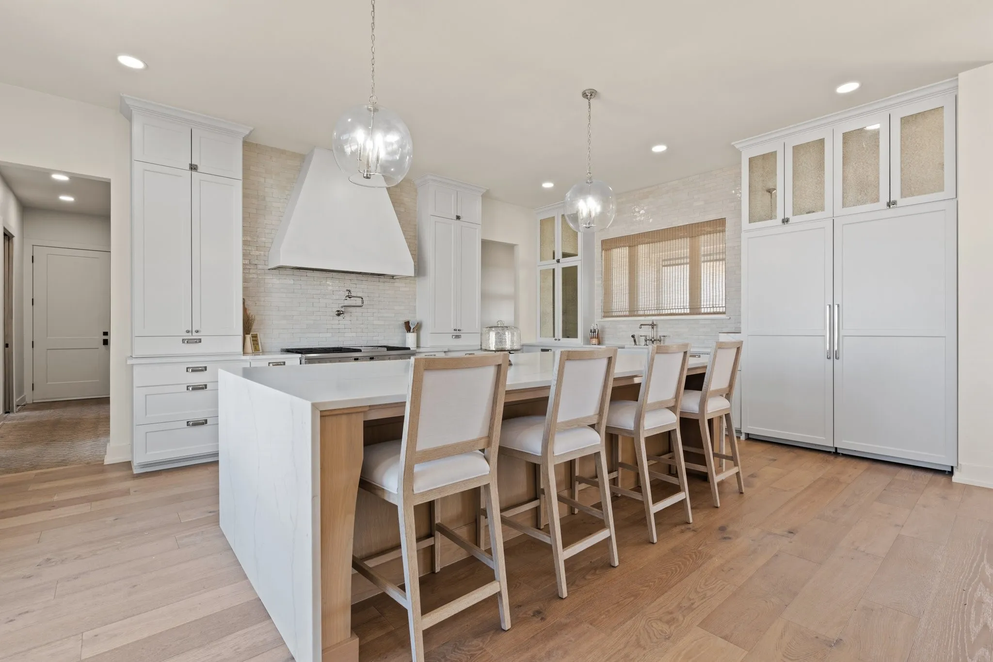 Built-in fridge, freezer blended seamlessly with custom cabinetry for a sleek, sophisticated kitchen design.