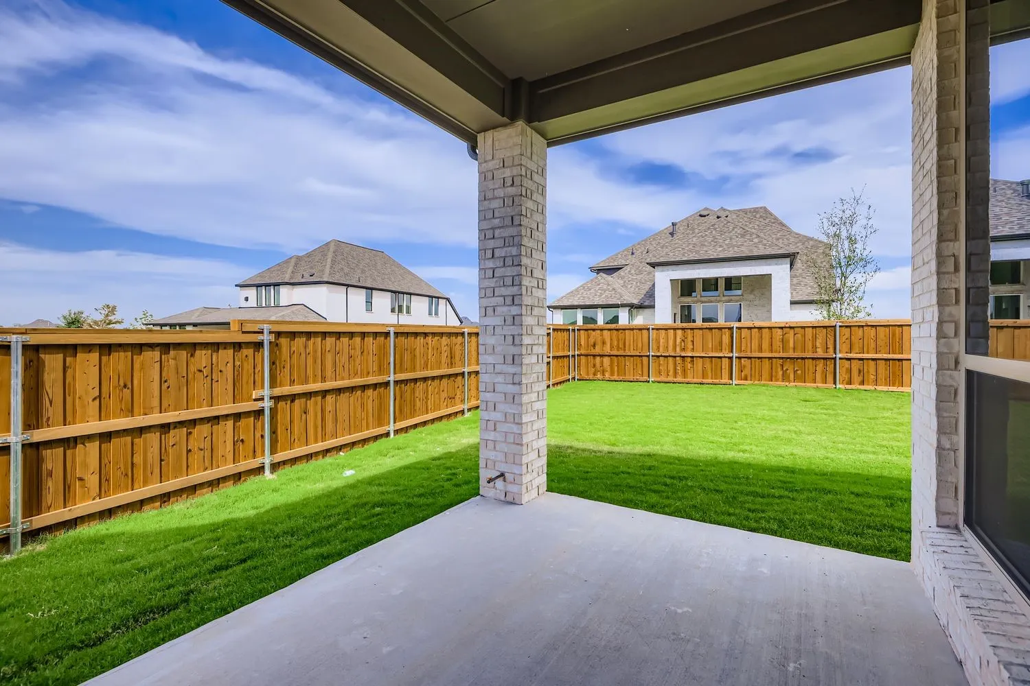 Fenced backyard with a patio