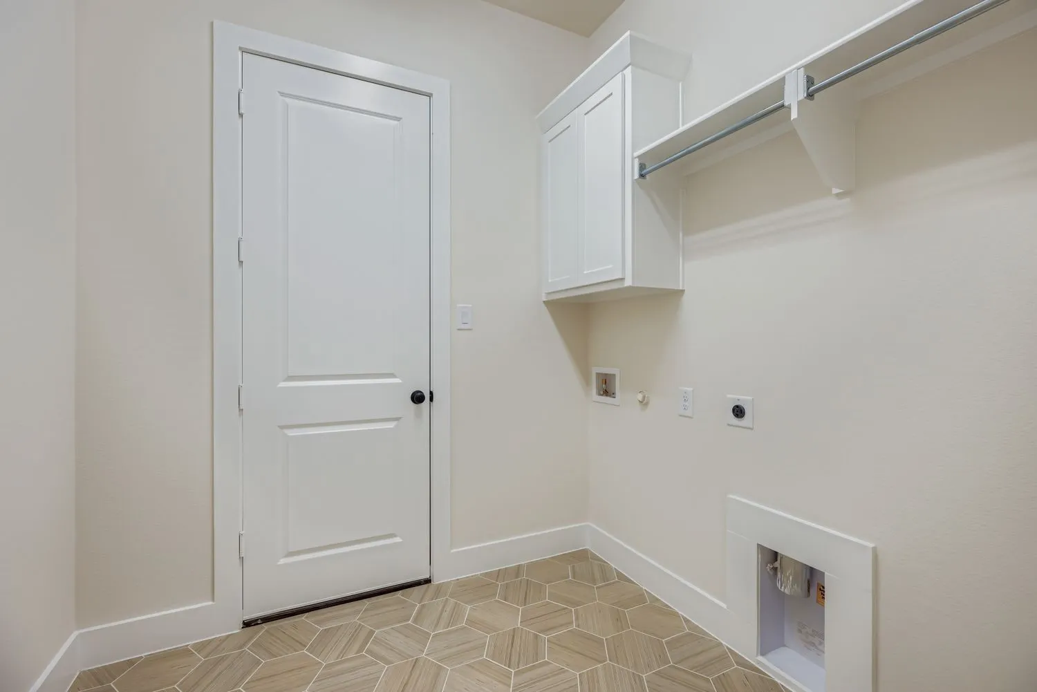Washroom featuring hookup for a gas dryer, washer hookup, electric dryer hookup, cabinet space, and light tile patterned floors