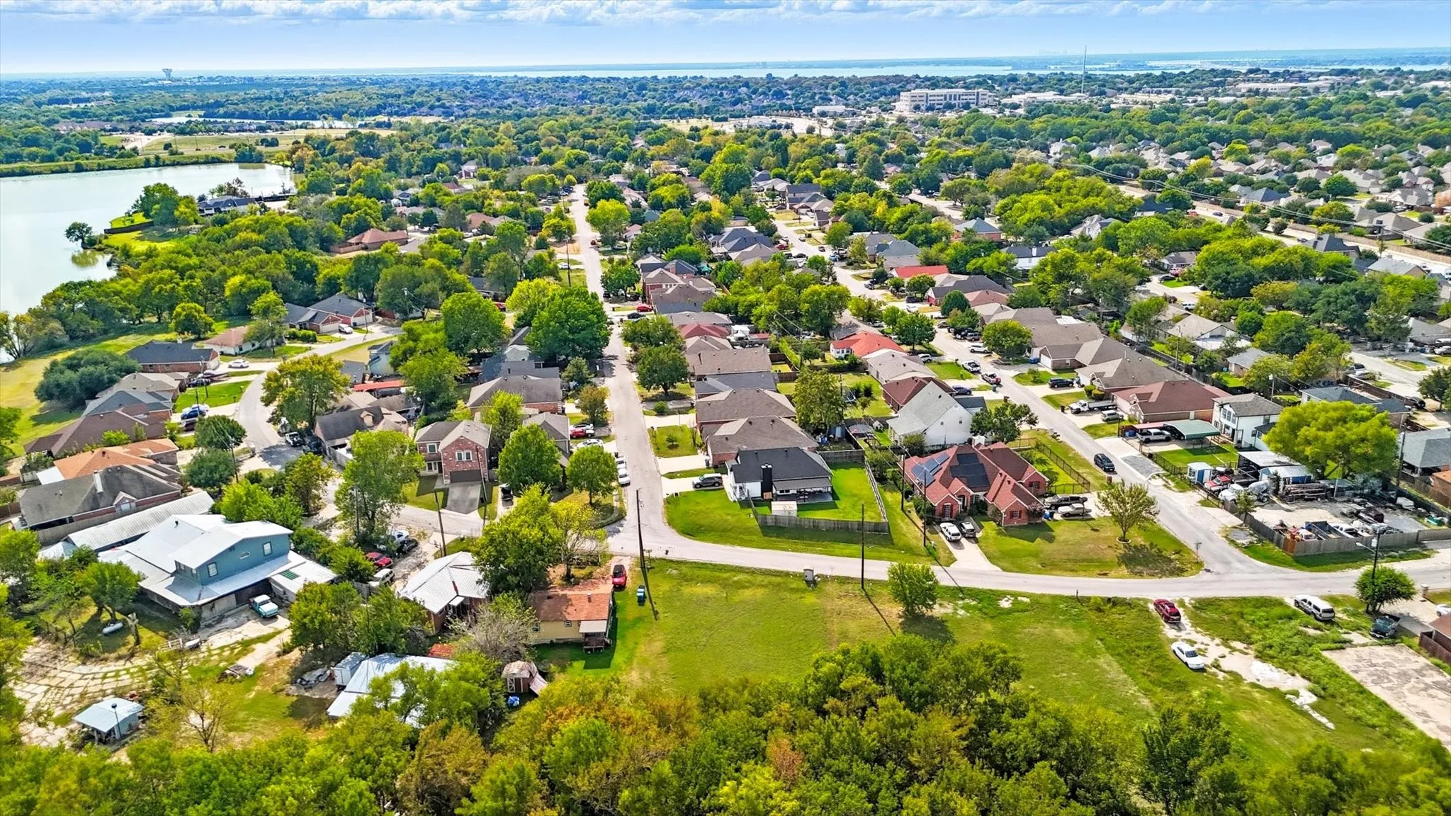 Aerial view of residential area featuring a large body of water