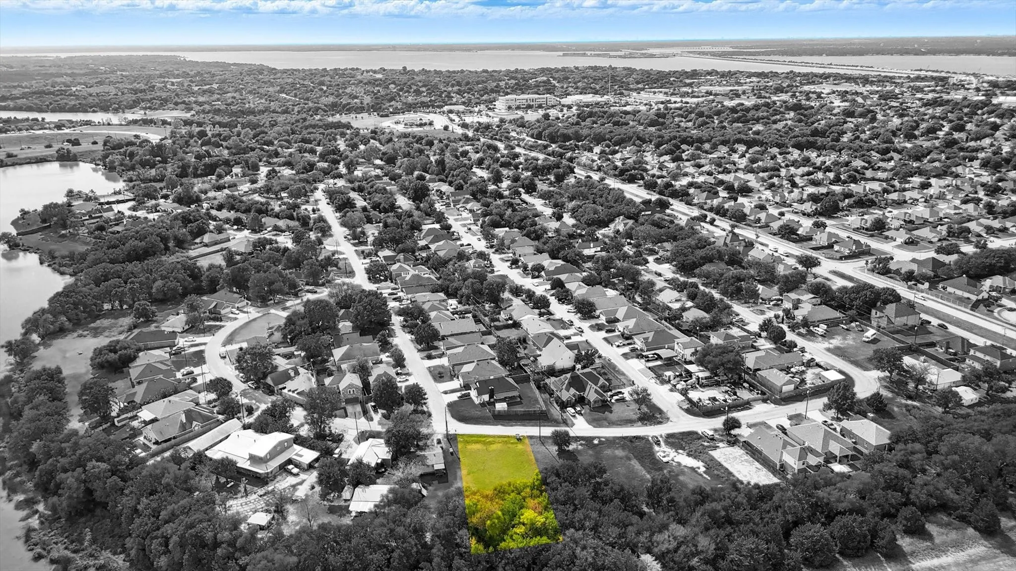 Aerial view of residential area featuring a nearby body of water