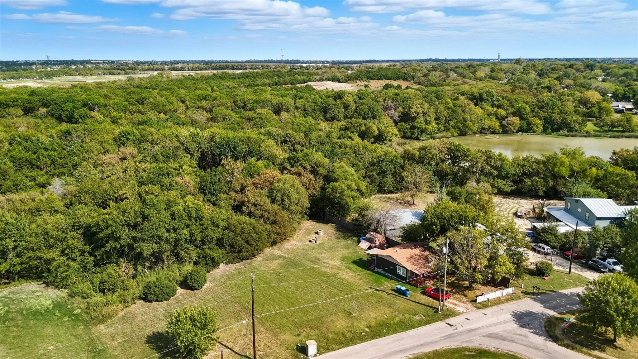 Bird's eye view of a heavily wooded area and a large body of water
