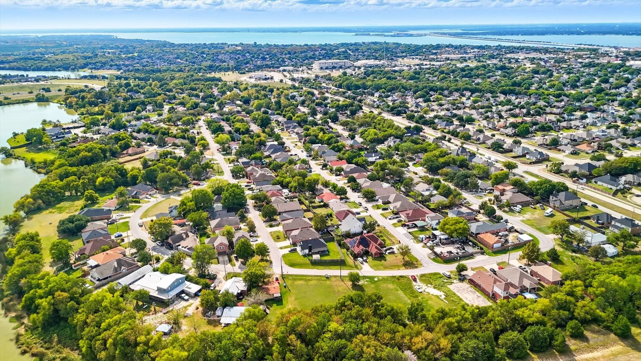 Aerial perspective of suburban area with a large body of water
