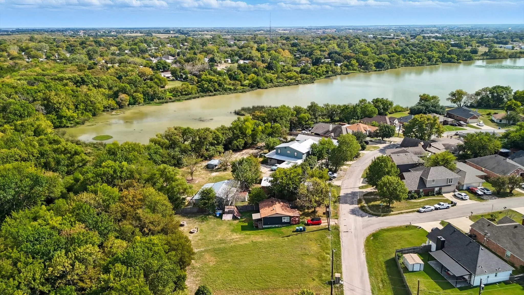 Aerial perspective of suburban area with a large body of water