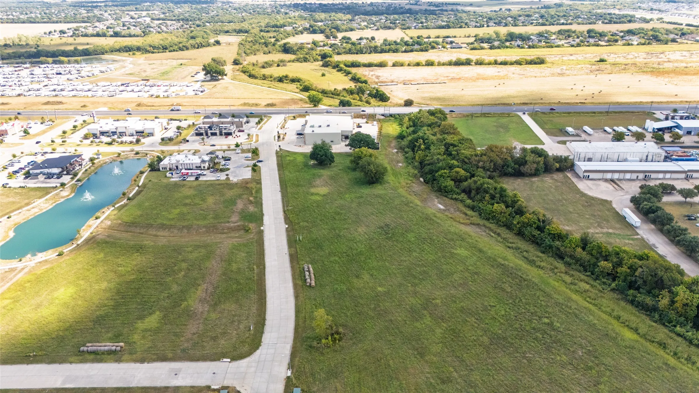 Aerial view of property's location with a large body of water