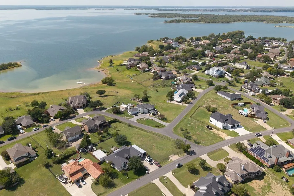 Aerial view of property's location with nearby suburban area and a nearby body of water