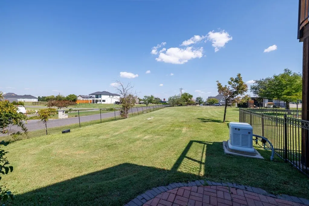 Fenced backyard with a residential view