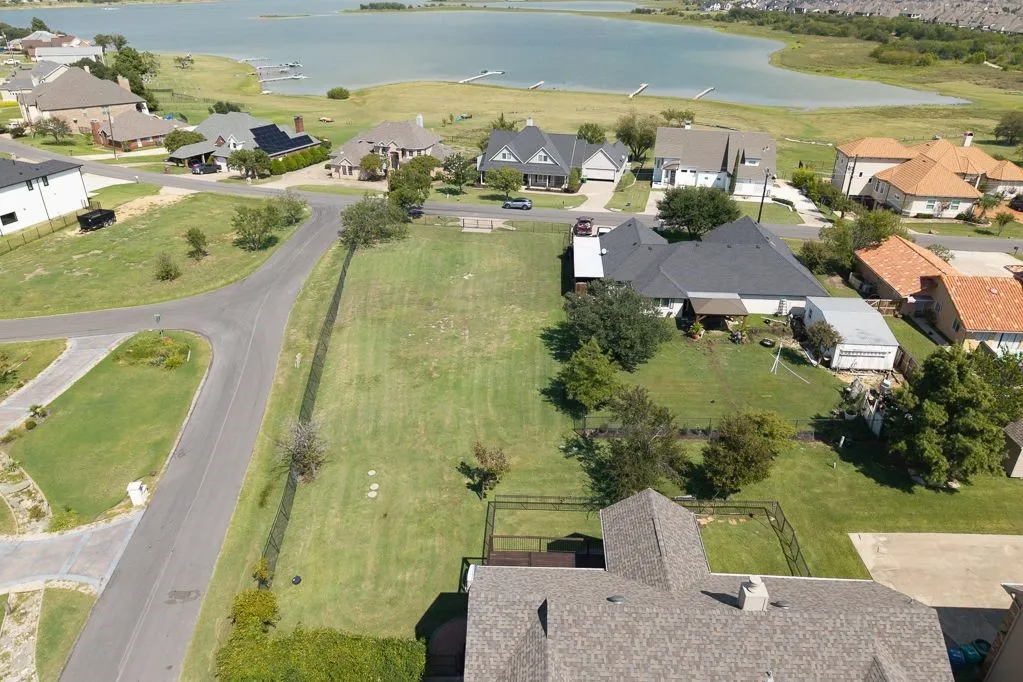 Aerial view of property's location featuring nearby suburban area and a nearby body of water