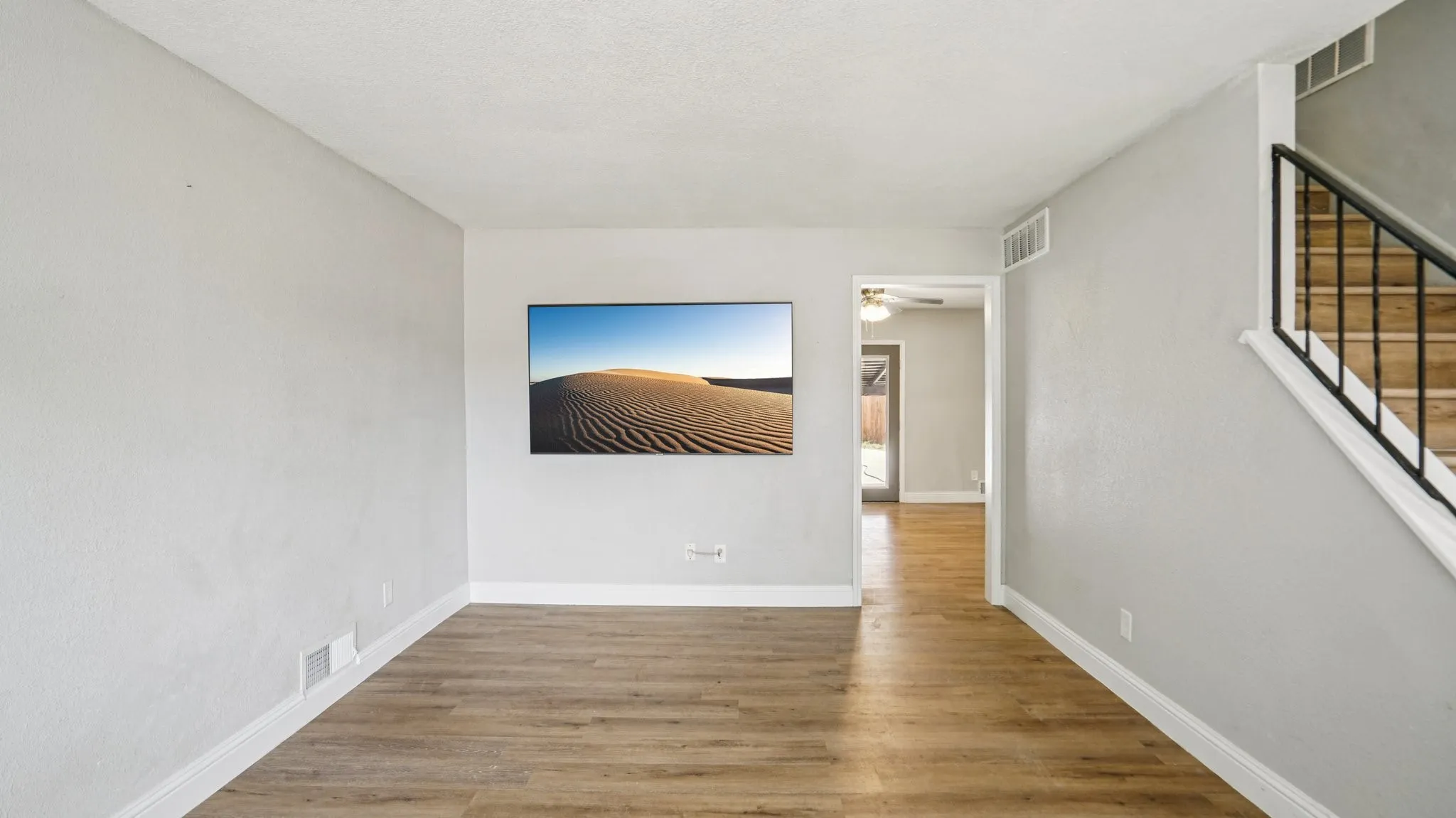 Empty room featuring light wood-style floors and stairway