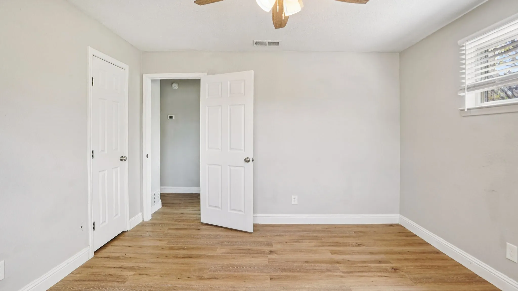Unfurnished bedroom with light wood-style flooring and a ceiling fan