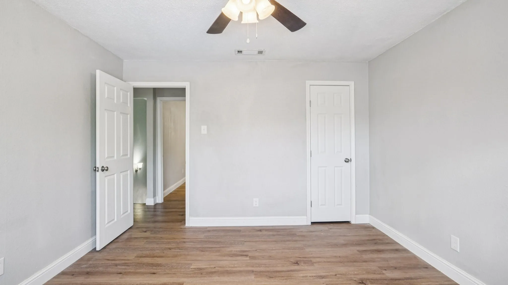 Unfurnished bedroom featuring light wood-style flooring and ceiling fan
