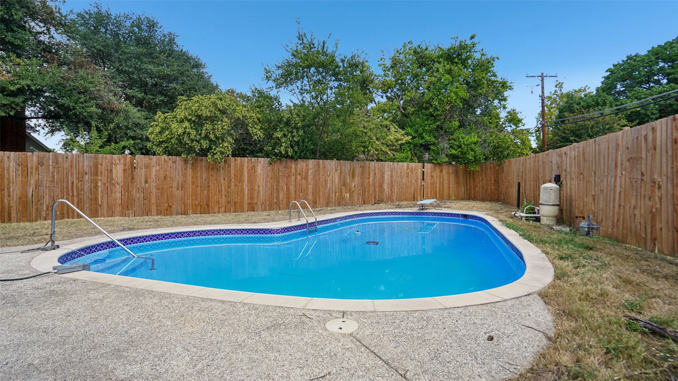 View of pool featuring a fenced backyard and a patio