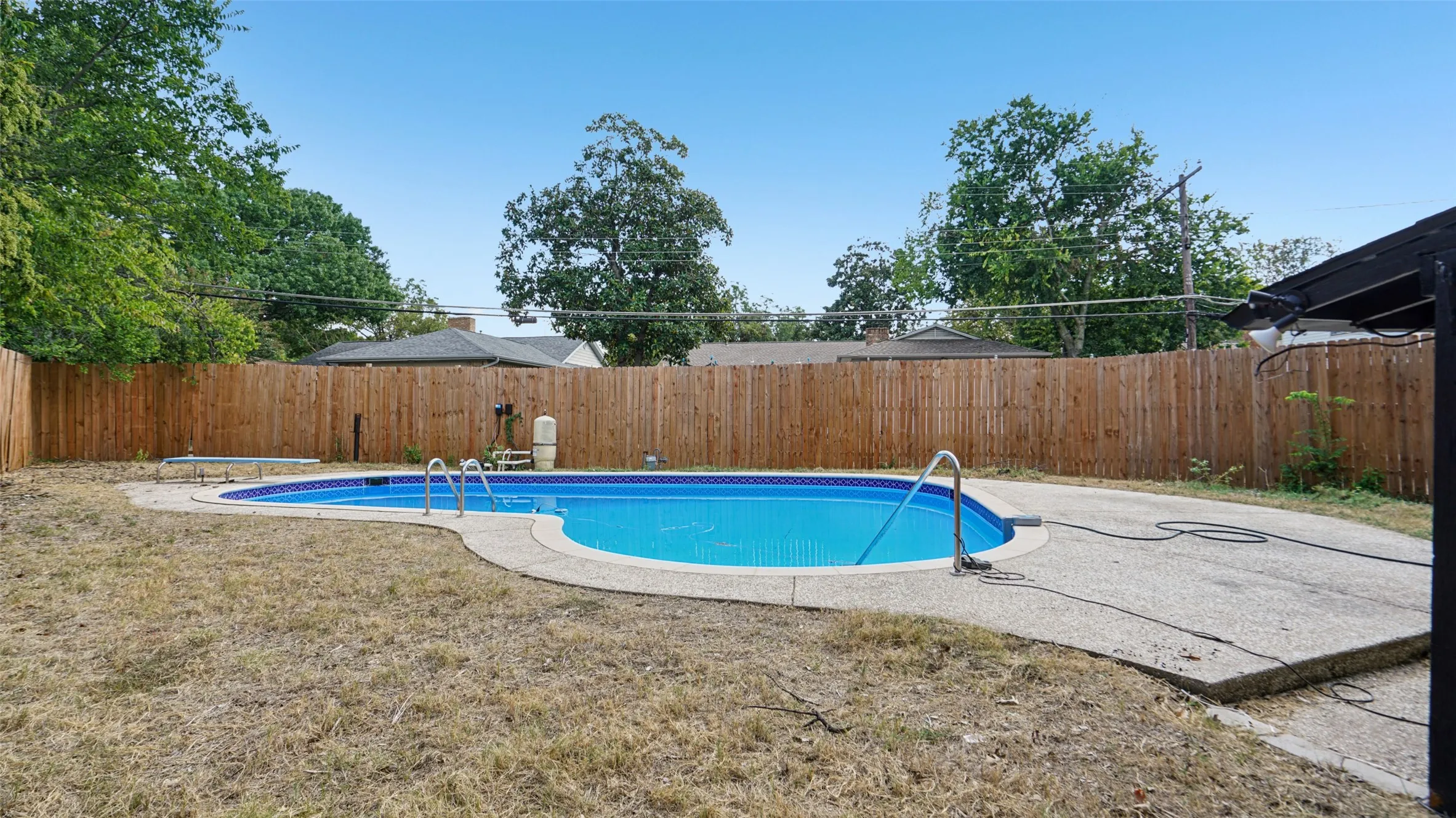 View of swimming pool featuring a fenced backyard and a patio