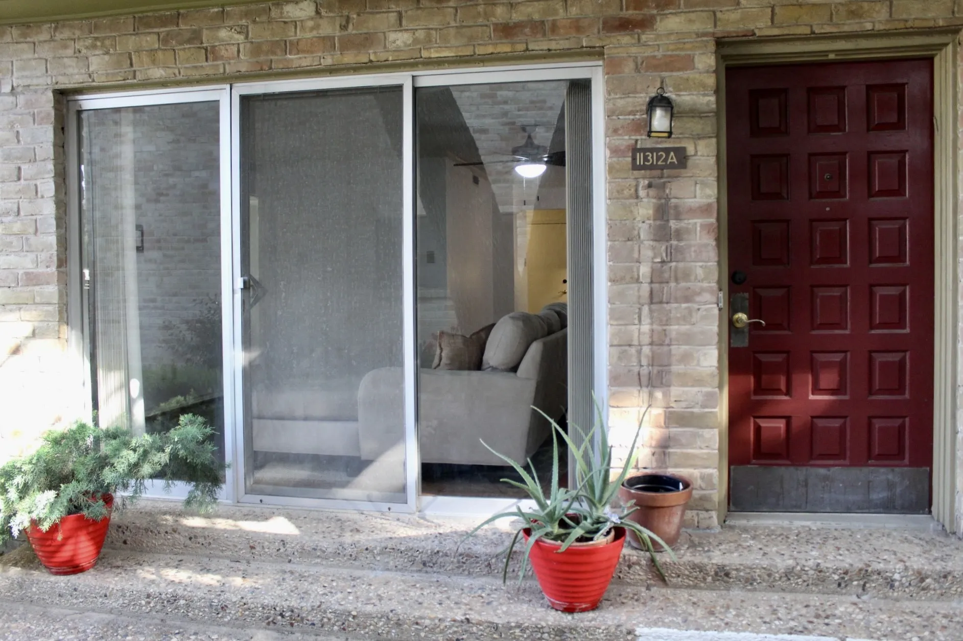 View of exterior entry with brick siding and stone siding