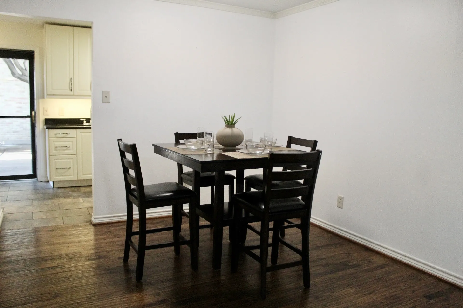 Dining area featuring dark wood-style floors and crown molding