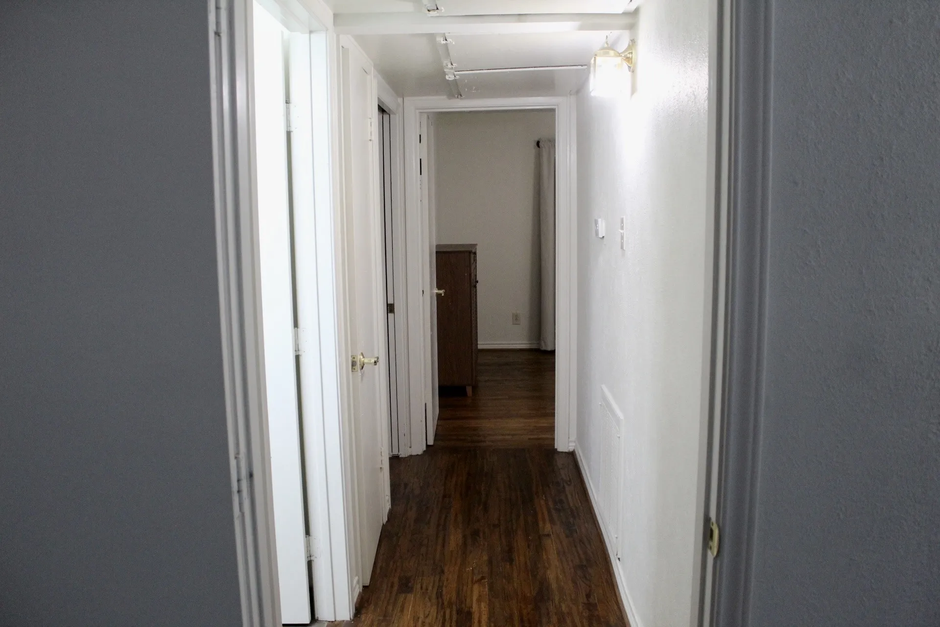Hall with dark wood-type flooring and attic access