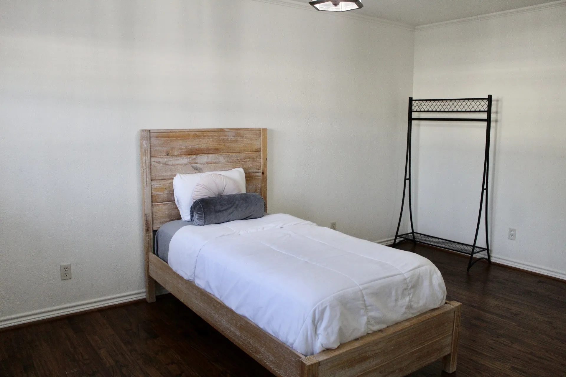 Bedroom with dark wood-style floors and ornamental molding