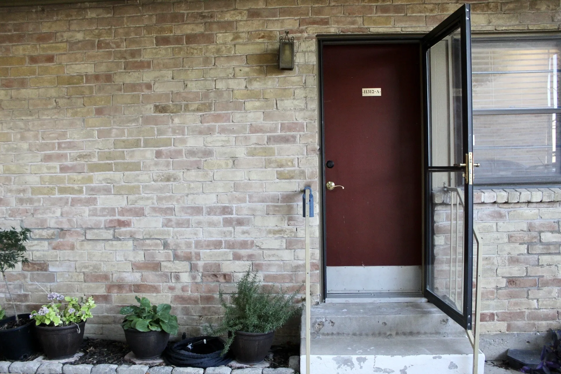 View of exterior entry featuring brick siding