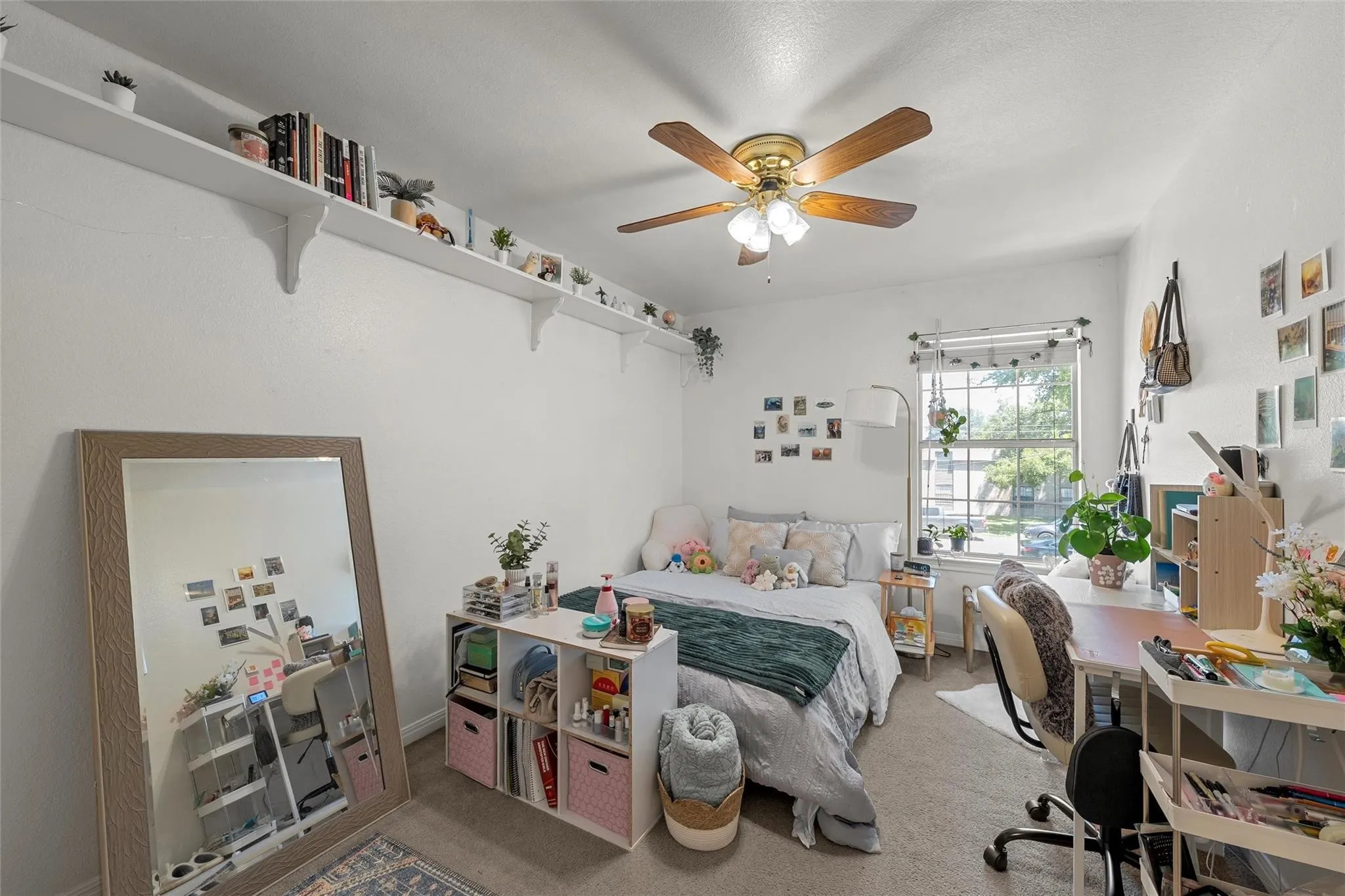 Bedroom with carpet, ceiling fan, and a desk