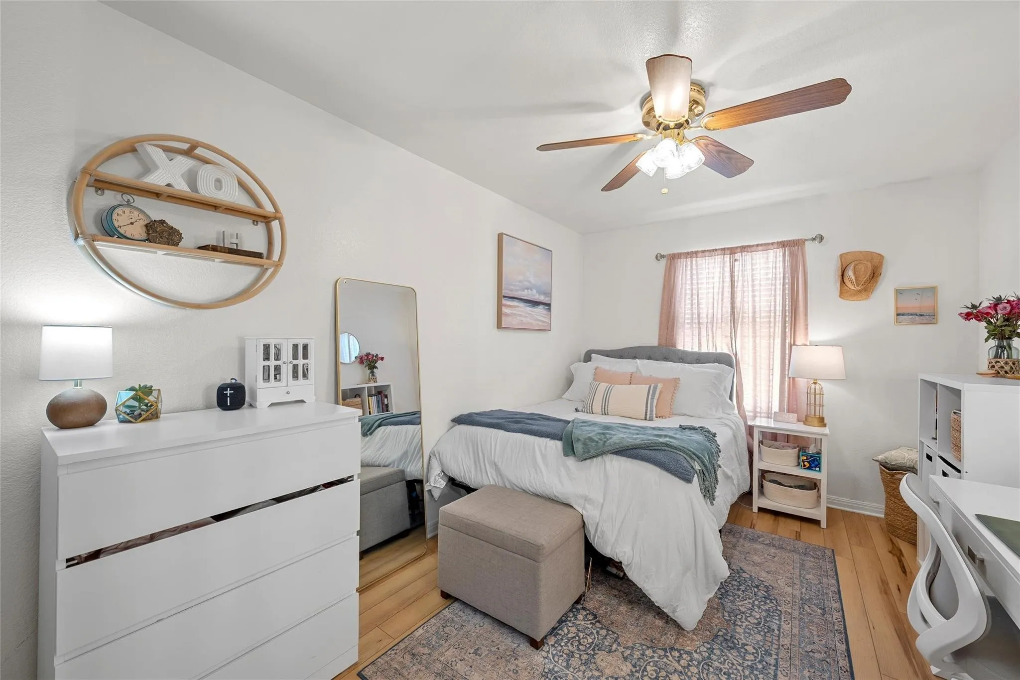 Bedroom with light wood-style floors and a ceiling fan