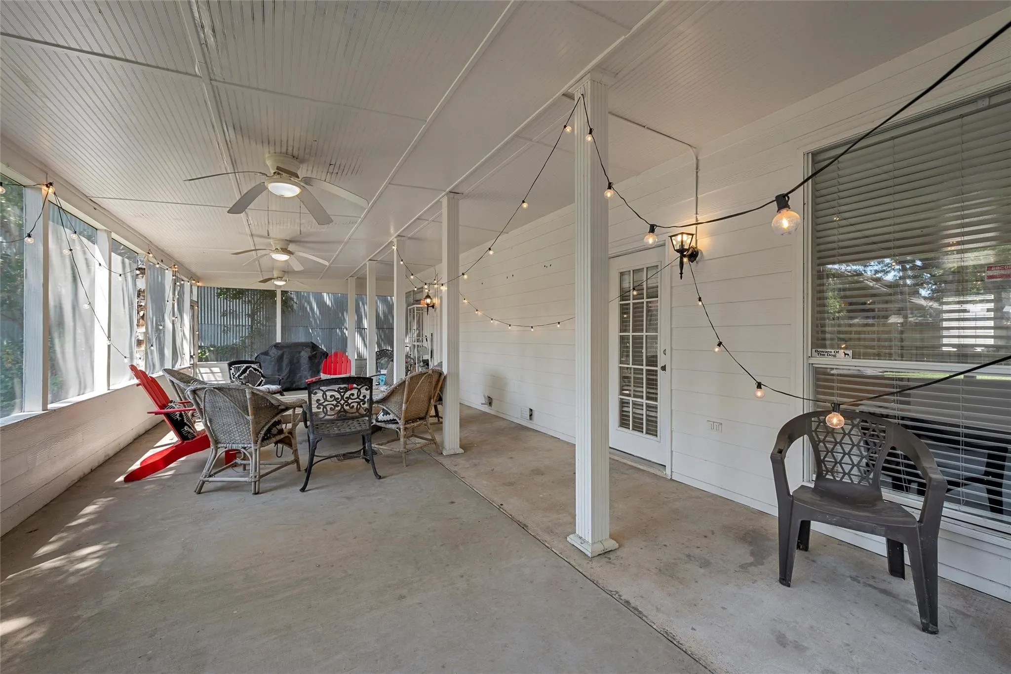 Sunroom with outdoor dining area, healthy amount of natural light, and a ceiling fan