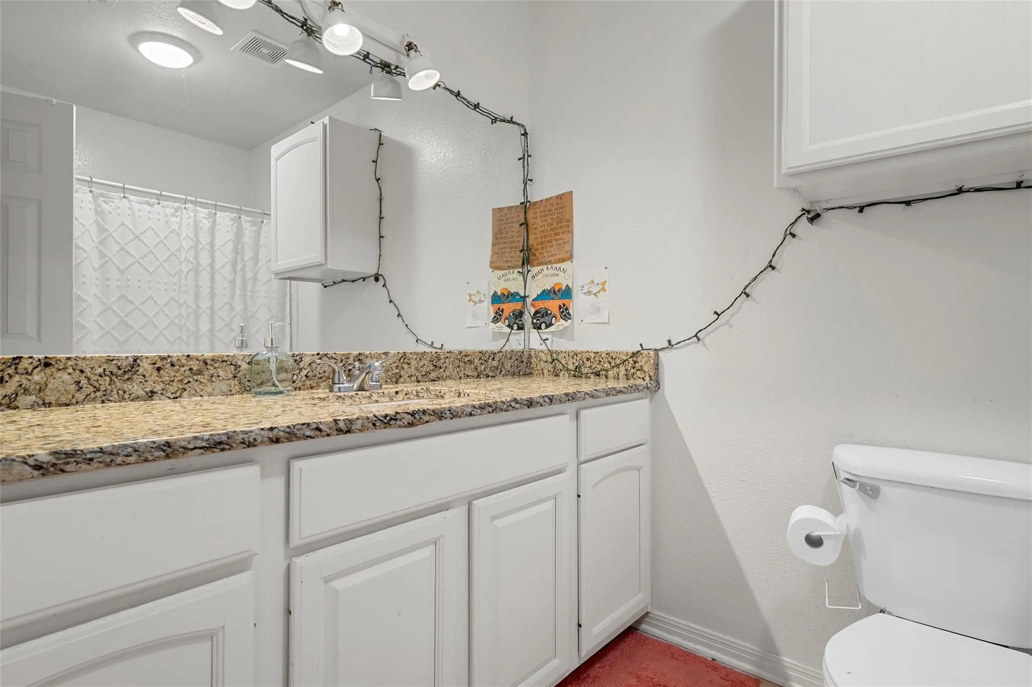 Full bathroom with vanity and toilet