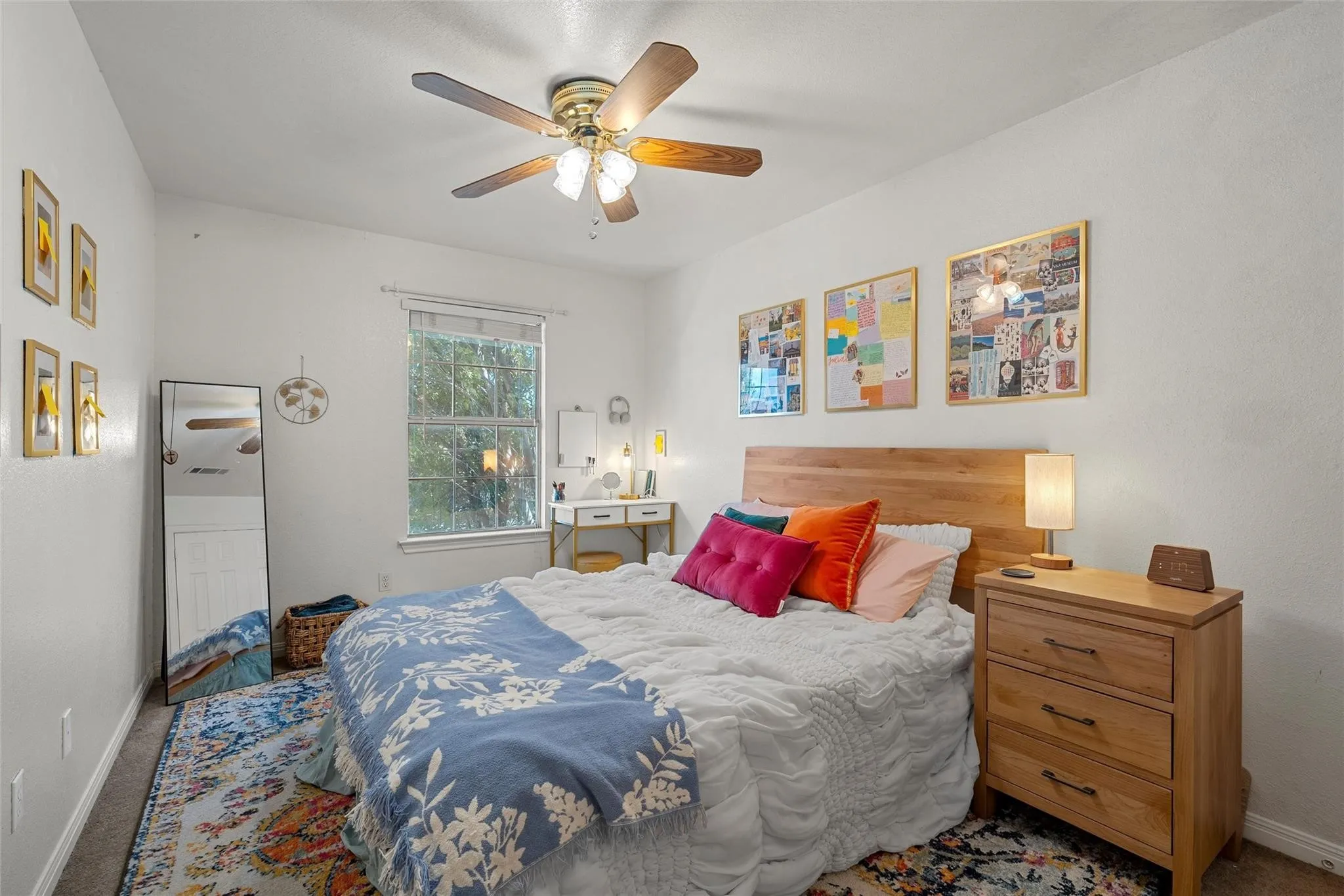 Carpeted bedroom featuring baseboards and a ceiling fan